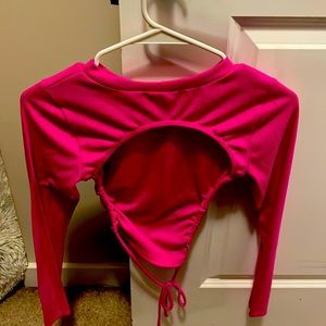 A pink crop top with an open back